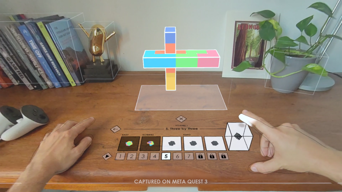 Cubism mixed reality gameplay: colorful puzzle blocks floating over a real wooden desk