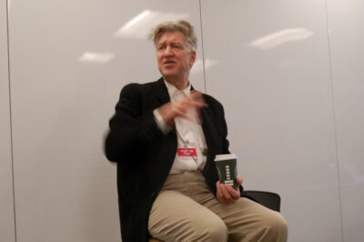 David Lynch speaking at an event, gesturing with his hands