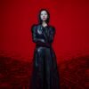 Kim Ji-won in a black leather coat against a red background in Doctor X: Mafia in White