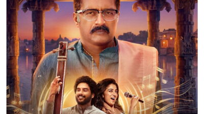 Prakash Raj holding a tanpura above the young leads of the Prime Video series Jagamae Sangeetham