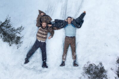 Ryan Reynolds and Kenneth Branagh lying in the snow in a publicity still for Mayday