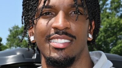 Washington Commanders quarterback Jayden Daniels smiling