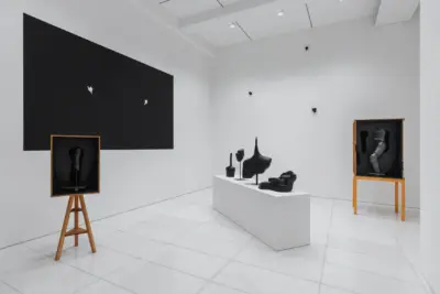 Installation view of KIM Inbai A Man Asleep at Arario Gallery Seoul showing dark sculptures and wooden boxes with blind tactile sculptures