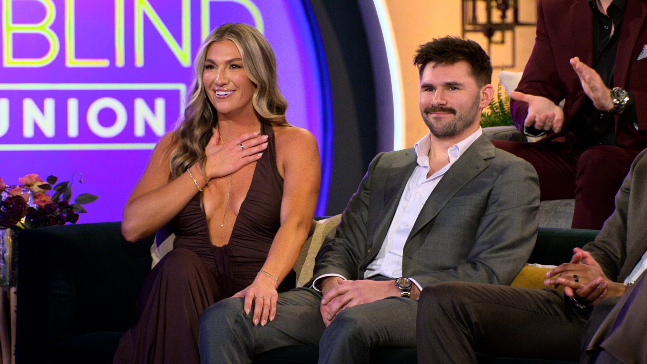 Love Is Blind season 10 couple smiling on the couch at the Ohio reunion on Netflix