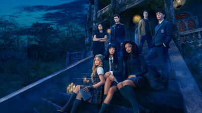 Coven Academy cast in school uniforms on the steps of a New Orleans mansion at dusk in the Disney+ key art, with Tiffani Thiessen and Devon Sawa behind them
