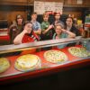 The teenage crew of the pizzeria behind the counter in Minimum Wage (Netflix)