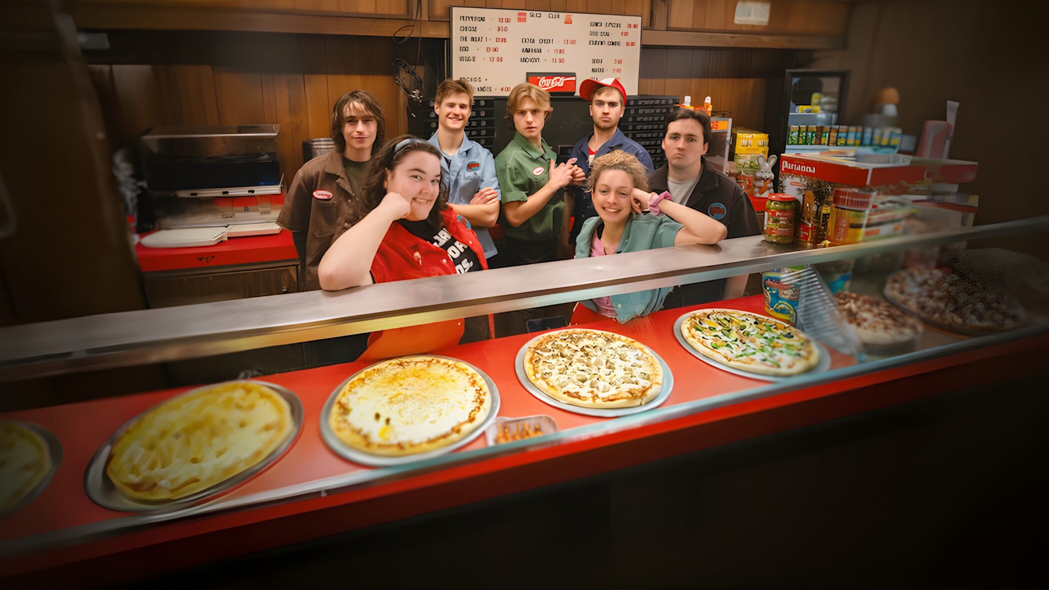 The teenage crew of the pizzeria behind the counter in Minimum Wage (Netflix)