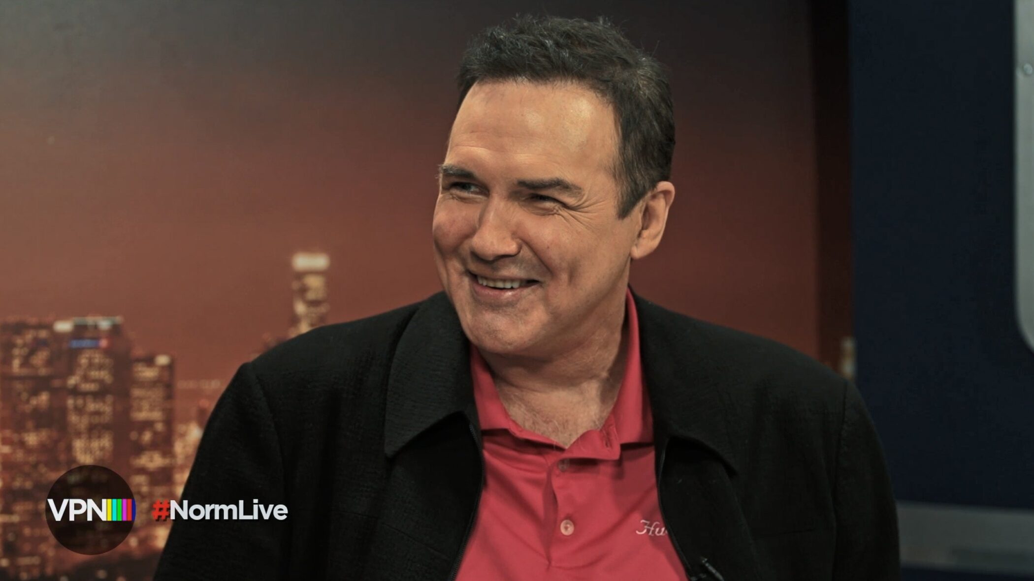 Norm Macdonald laughing during a television interview