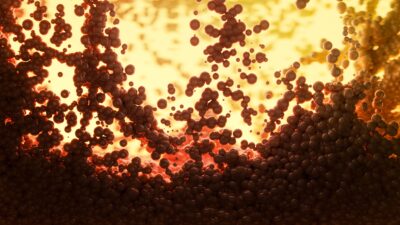 Simulated molten debris spheres ejected in a giant planetary impact, rendered in glowing amber tones