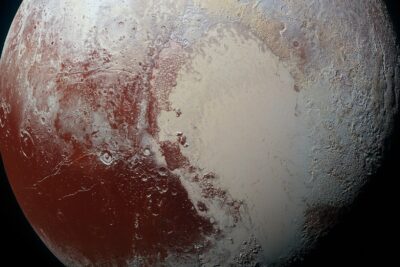 Pluto in enhanced color from NASA's New Horizons, with the pale heart-shaped Sputnik Planitia glacier