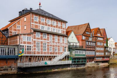 Historic red-brick buildings along Am Stintmarkt waterfront in Lueneburg, Germany