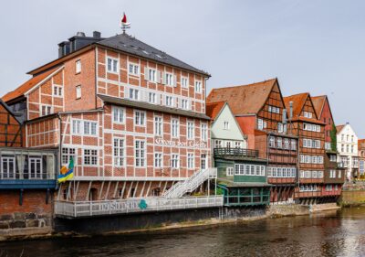Historic red-brick buildings along Am Stintmarkt waterfront in Lueneburg, Germany