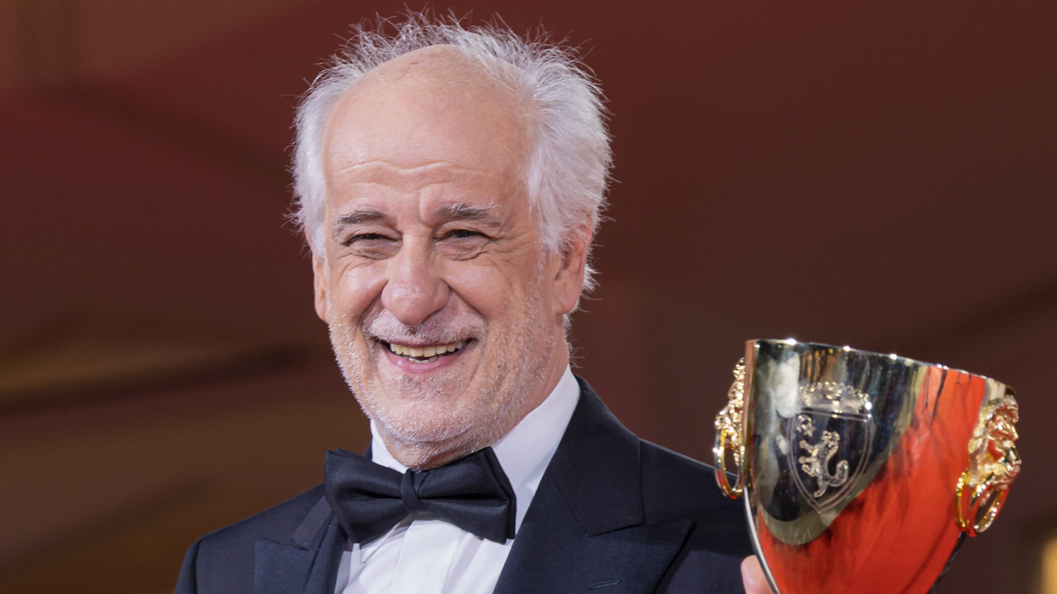 Italian actor Toni Servillo with the Coppa Volpi at the 82nd Venice Film Festival