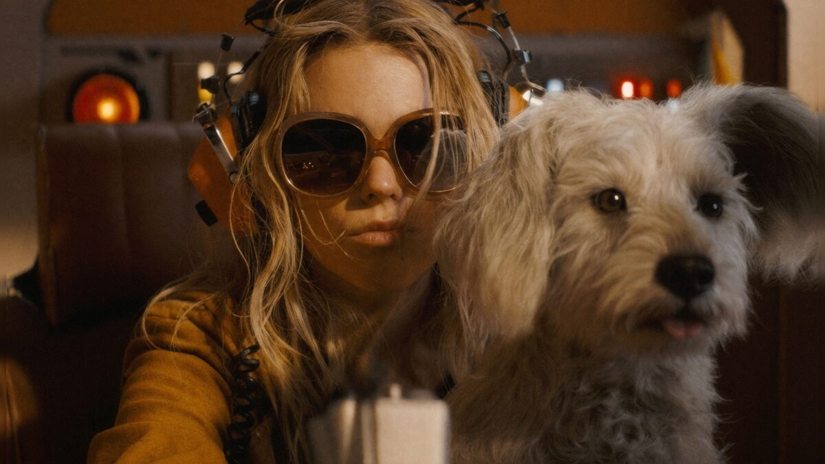 Milly Alcock as Kara Zor-El with her dog Krypto in a scene from the Supergirl film