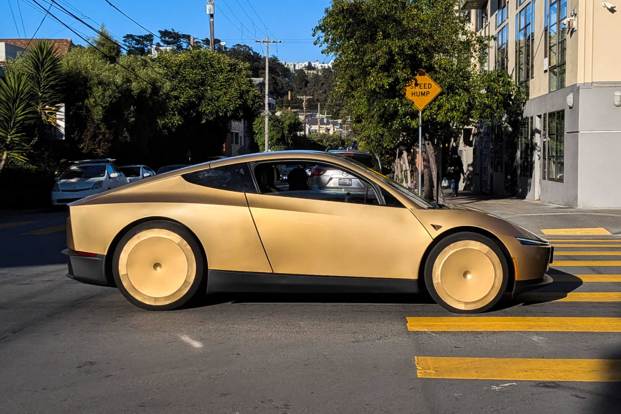 Tesla Cybercab autonomous vehicle on a public street with no visible steering wheel