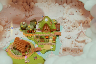 Woodo overhead view of a half-assembled diorama world, half colorful and half unpainted