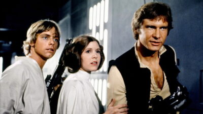 Mark Hamill, Carrie Fisher and Harrison Ford as Luke Skywalker, Princess Leia and Han Solo in Star Wars (1977)