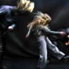 100%WET (Jakob Birch, Casper Munns and Sanna Heinstedt) headbanging against a black backdrop