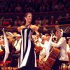 Anton Du Beke in white tie performing with Erin Boag in front of an orchestra at Symphony Hall, Birmingham