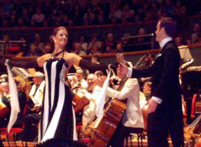 Anton Du Beke in white tie performing with Erin Boag in front of an orchestra at Symphony Hall, Birmingham