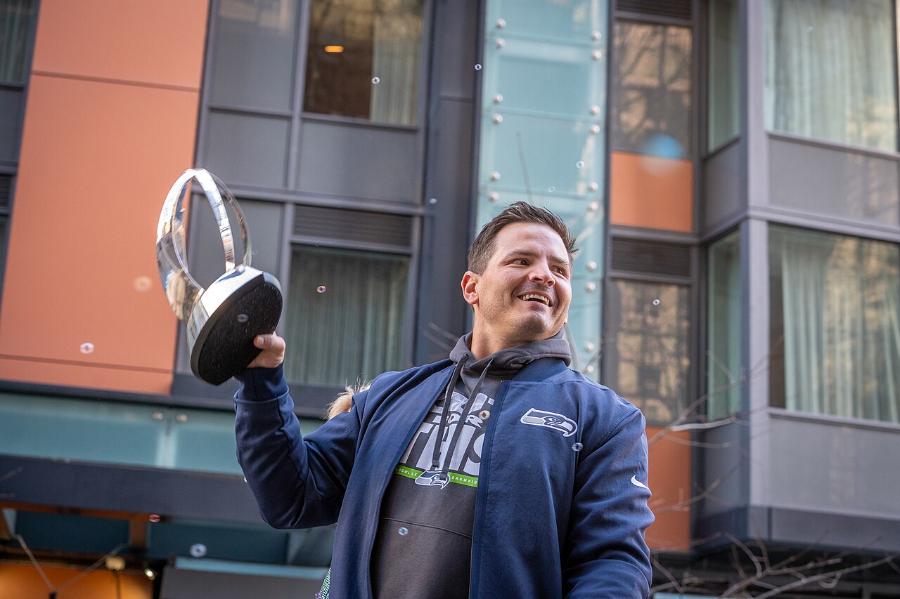 Seattle Seahawks head coach Mike Macdonald raising the Vince Lombardi Trophy during the Super Bowl LX victory parade in Seattle