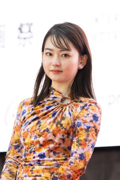 Anna Yamada, with shoulder-length dark hair and a floral long-sleeved dress, on the opening red carpet of the Tokyo International Film Festival for Mountain Woman, October 2022