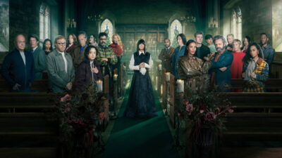 The Celebrity Traitors series 2 cast in a candlelit chapel, with host Claudia Winkleman standing in the aisle