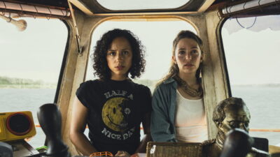 Kiana Madeira and Jessica Rothe in the wheelhouse of a river boat in a still from Mike P. Nelson's Beware Boiúna