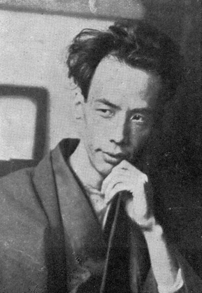 Ryūnosuke Akutagawa, black-and-white portrait, chin resting on his hand, 1927