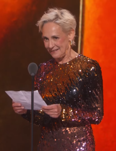 Laurie Metcalf in a sequinned gown reading her acceptance speech at the 79th Tony Awards, June 2026