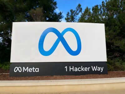 The Meta infinity logo sign at the entrance to the company's headquarters at 1 Hacker Way, Menlo Park, California