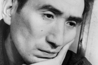 Osamu Dazai, black-and-white portrait, chin resting on his hand, February 1948