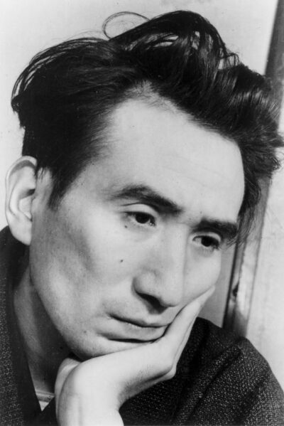 Osamu Dazai, black-and-white portrait, chin resting on his hand, February 1948