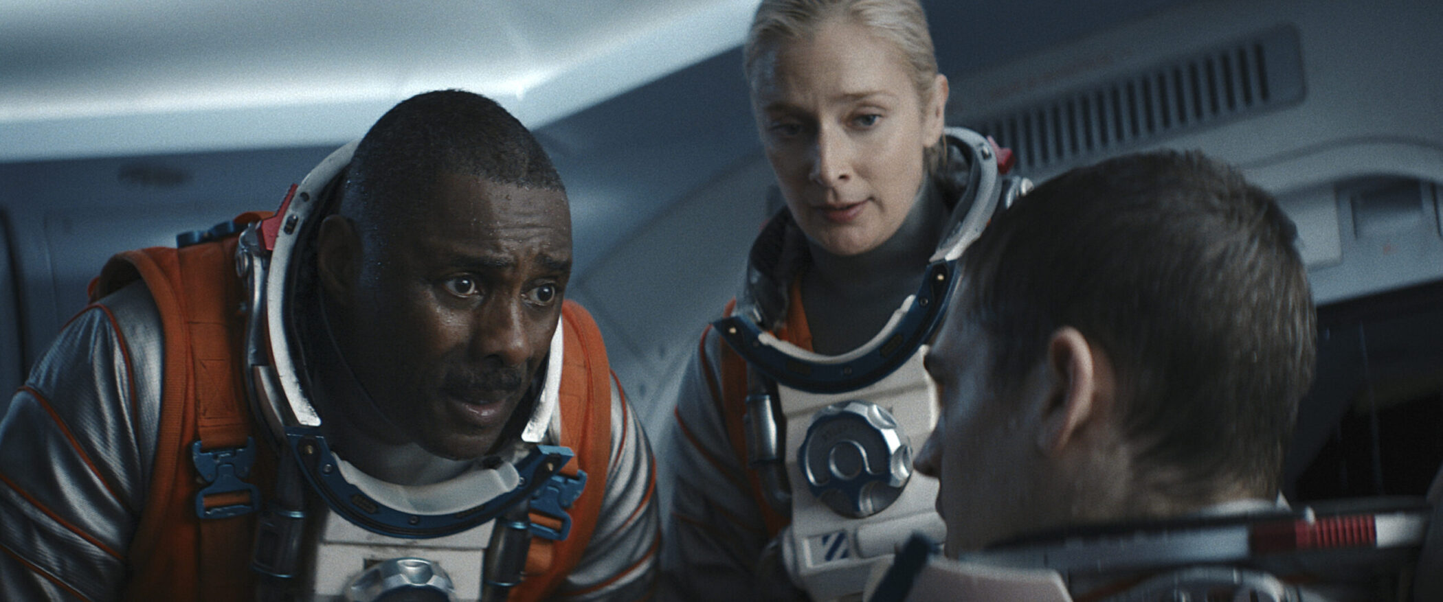 Idris Elba, Caitlin FitzGerald and Hero Fiennes Tiffin as astronauts inside the capsule in Above the Below