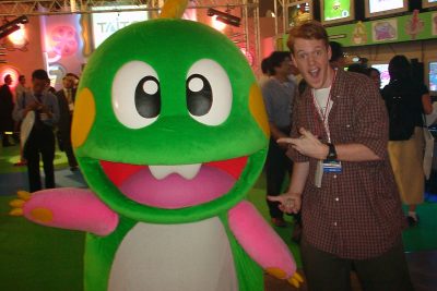 Journalist Colin Williamson posing with a Bub mascot costume at Tokyo Game Show 2000
