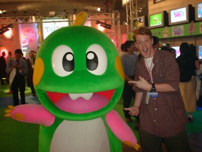 Journalist Colin Williamson posing with a Bub mascot costume at Tokyo Game Show 2000