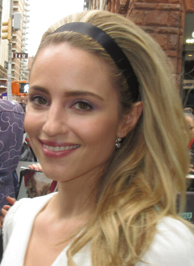 Dianna Agron smiling outdoors in New York, wearing a black headband