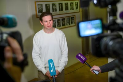 Dmitry Lysenkov, in a white sweatshirt, answers press questions at the opening of the Golden Mask programme in Saint Petersburg, 2021
