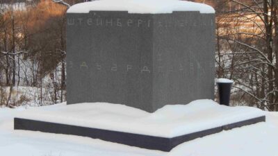 Granite cube monument to the painter Eduard Steinberg at the old cemetery in Tarusa, Russia, under snow