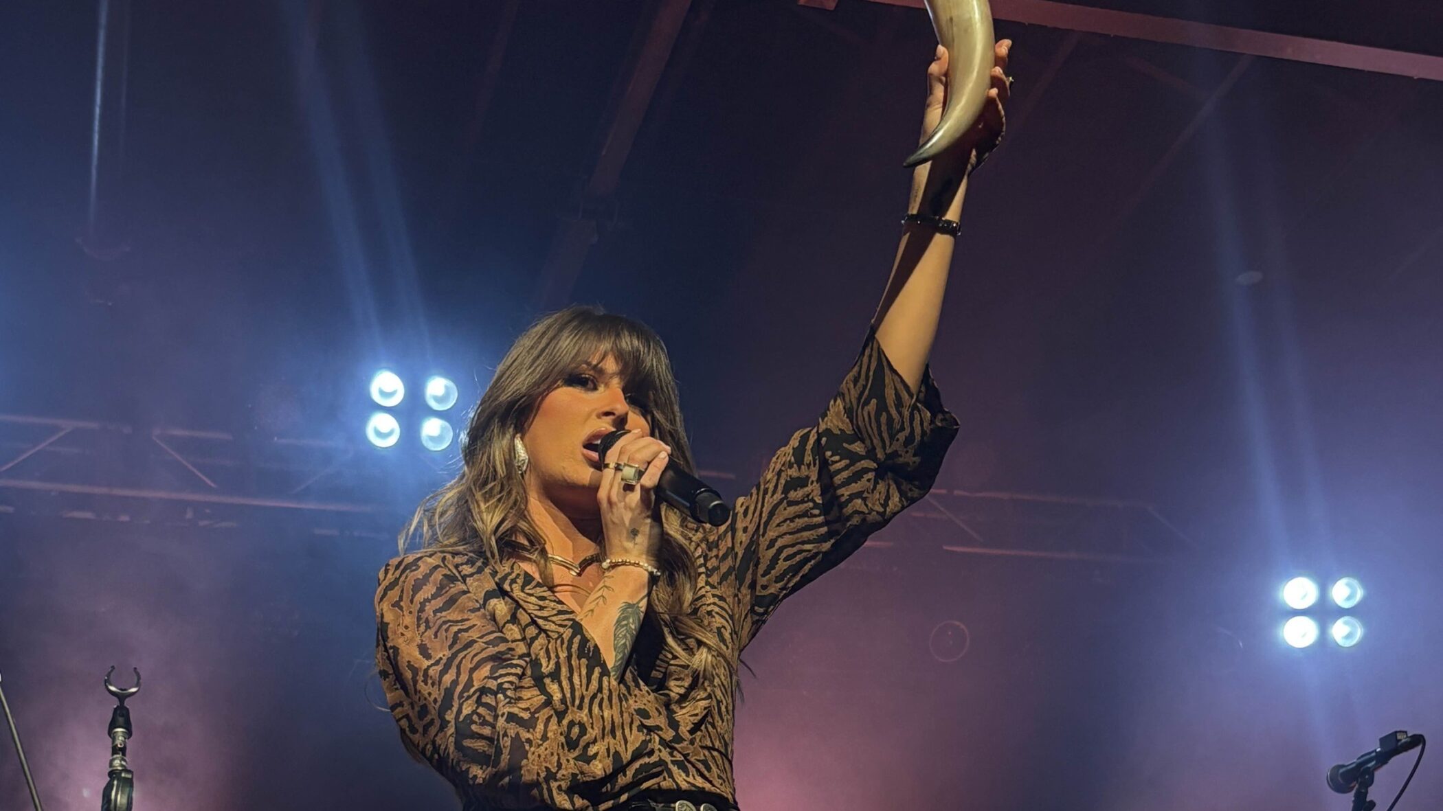 Ella Langley singing on stage in concert, 2025