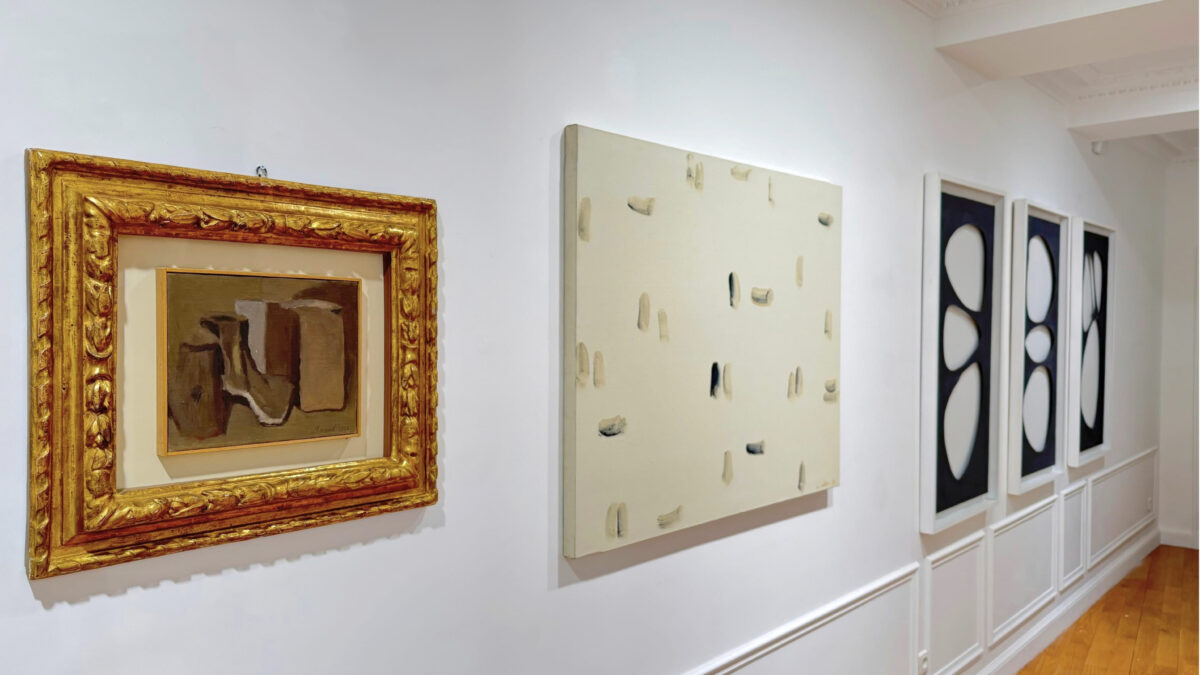 A small Morandi still life in a gilded frame beside a pale canvas of scattered brushstrokes