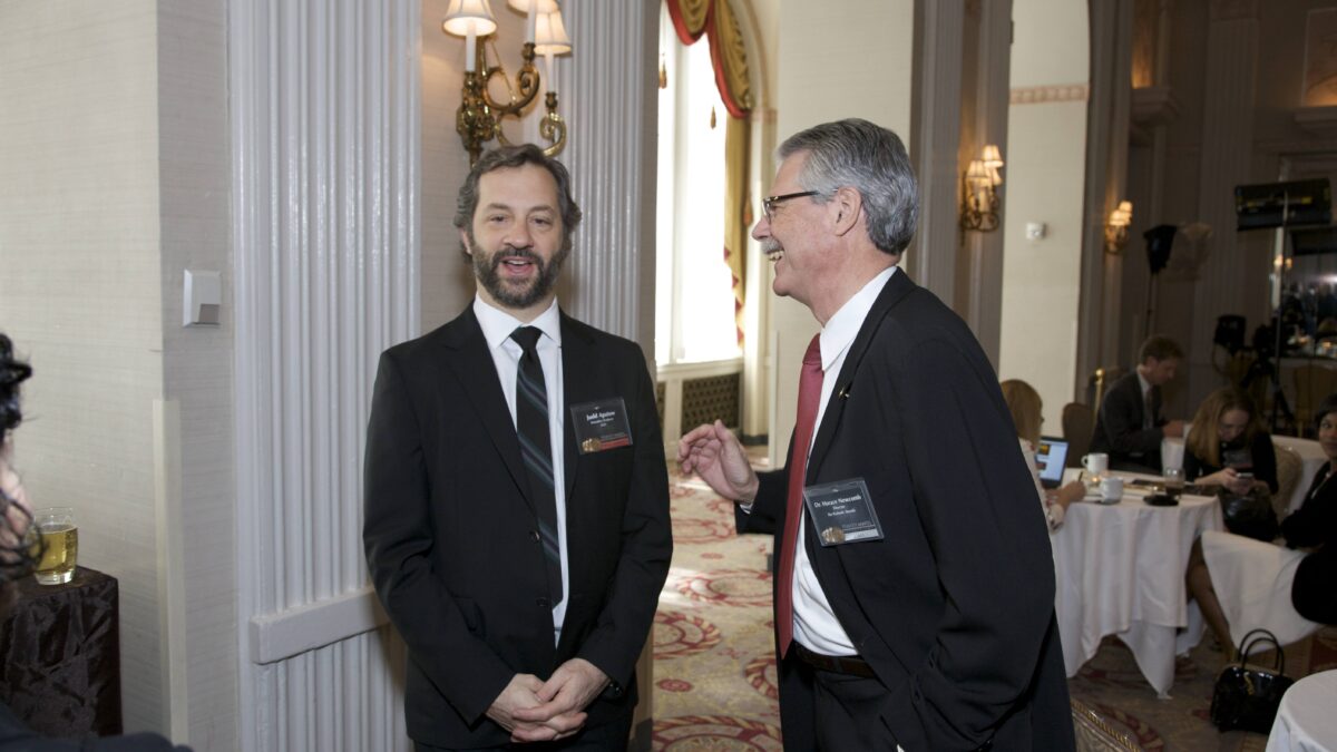 Judd Apatow in a dark suit talking with Horace Newcomb at the Peabody Awards luncheon