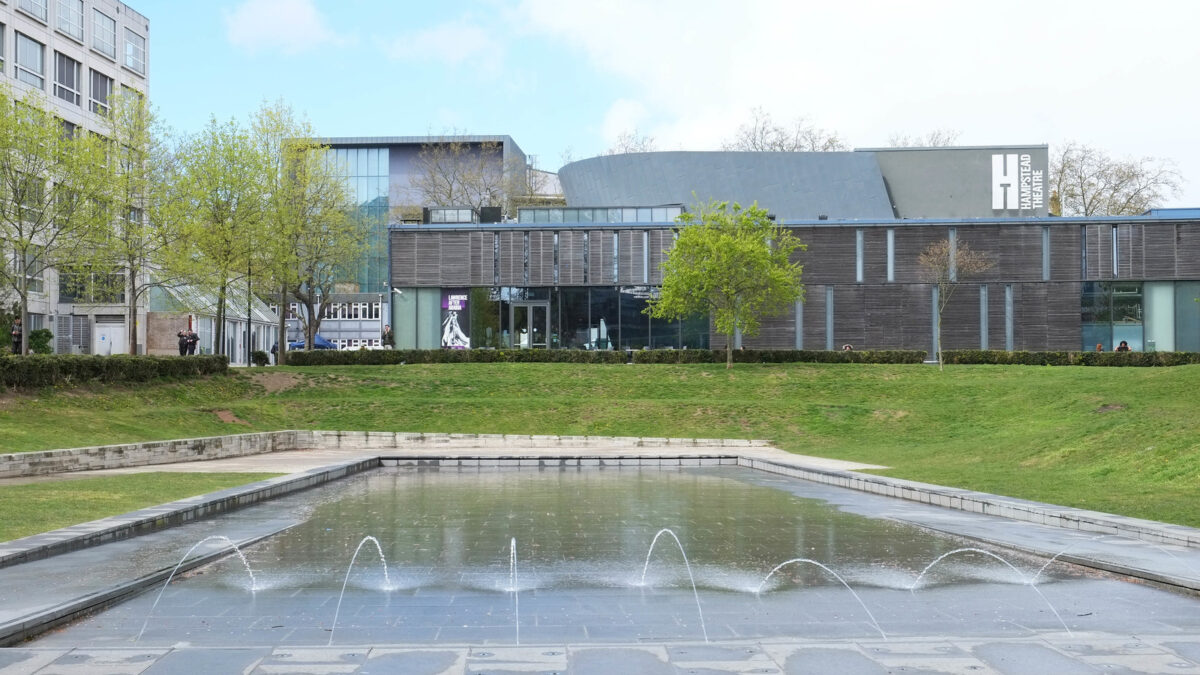 Hampstead Theatre building seen across the Swiss Cottage open space and fountain pool