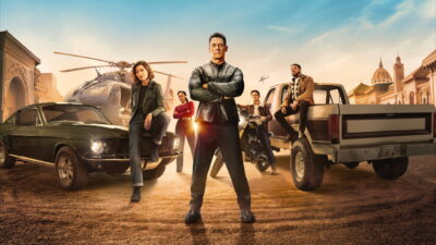 John Cena and the ensemble cast pose with a muscle car, a motorcycle, a pickup truck and a helicopter in key art for Matchbox the Movie