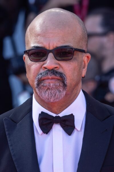 Jeffrey Wright in a black tuxedo and tinted glasses on the red carpet at the 2025 Venice Film Festival