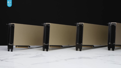 Four NVIDIA H100 data-centre GPU cards lined up on a marble surface