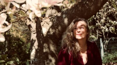 Magnolia Shade vocalist Susanne Kristensen under a blossoming magnolia tree