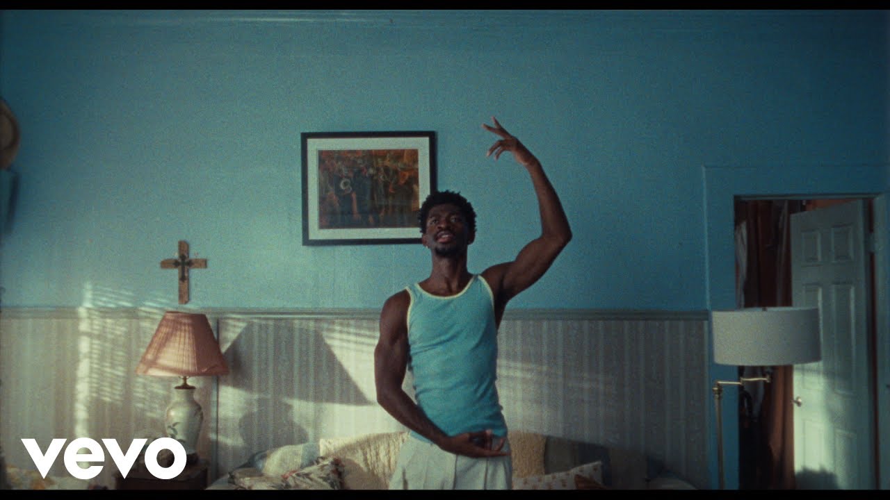 Lil Nas X dancing in a blue living room in the World’s Greatest! music video