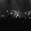 YUNGBLUD and Billy Corgan performing Zombie with the band on the Riviera Theatre stage in Chicago, in a black-and-white still from the live video