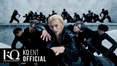 ATEEZ in black leather on the icy set of the Drip music video, with a line of dancers behind them